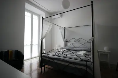 a bedroom with a bed with a glass canopy at Apartment Ostiense Piramide Station in Rome
