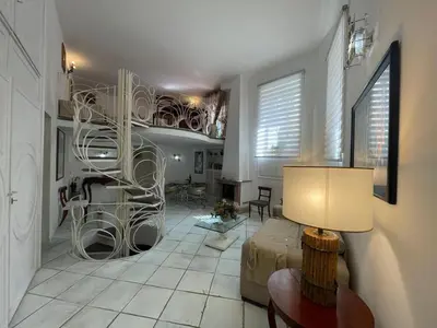 a living room with a spiral staircase in a room at Foro Romano Apartments A in Rome