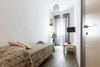a hotel room with a bed and a table at Cornelia House in Rome
