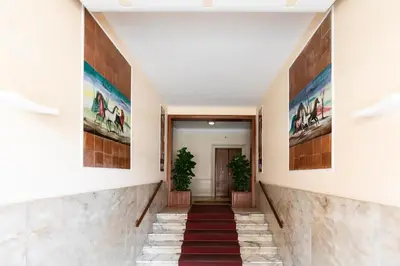 a hallway of a building with paintings on the walls at Cornelia House in Rome