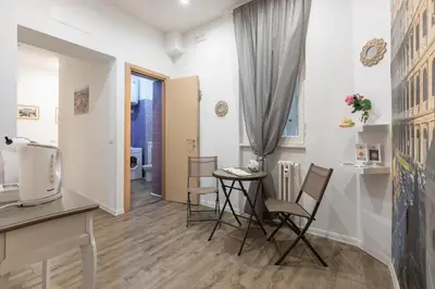 a living room with a table and chairs and a television at Cornelia House in Rome