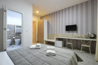 a bedroom with a bed and a desk and a television at Vatican Nausicaa in Rome