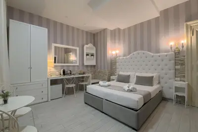 a bedroom with a large white bed and a desk at Vatican Nausicaa in Rome