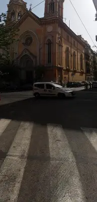 a white limo parked in front of a church at Filiberto Apartment in Rome