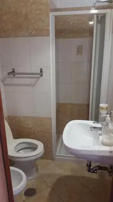 a bathroom with a toilet and a sink at Filiberto Apartment in Rome
