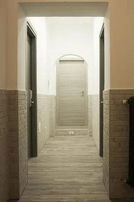 a hallway with a door in a room with wooden floors at Hotel Agorà in Rome