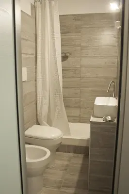 a bathroom with a toilet and a shower and a sink at Hotel Agorà in Rome