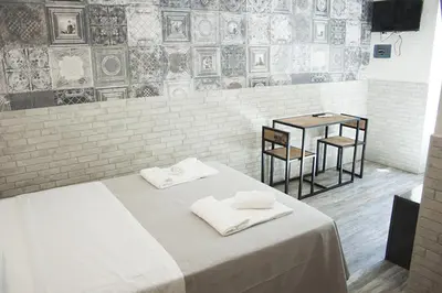 a room with a bed with two white towels on it at Hotel Agorà in Rome