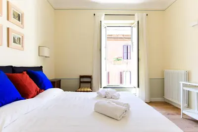 a bedroom with a white bed with towels on it at Bright and Comfy 3 bedroom apt in Monti in Rome