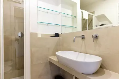 a bathroom with a sink and a shower at Bright and Comfy 3 bedroom apt in Monti in Rome