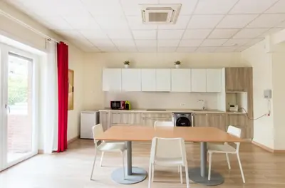 a kitchen with a wooden table and white cabinets at Vetere 101 Apartment in Rome