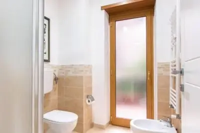 a bathroom with a toilet and a sink at Vetere 101 Apartment in Rome
