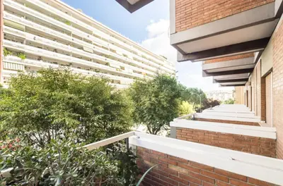 an external view of a brick building with trees at Vetere 101 Apartment in Rome
