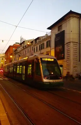 a train is traveling down a city street at Your secret place in Rome in Rome