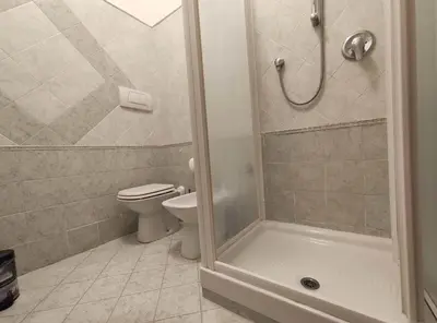 a bathroom with a toilet and a shower at Your secret place in Rome in Rome