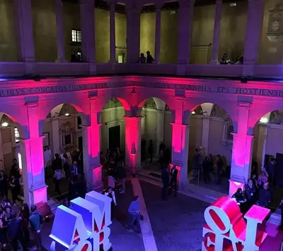 a group of people in a building with pink lights at Your secret place in Rome in Rome