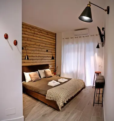 a bedroom with a large bed with a wooden headboard at Antinori Vatican Suite in Rome