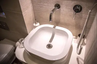 a bathroom with a white toilet and a sink at Antinori Vatican Suite in Rome