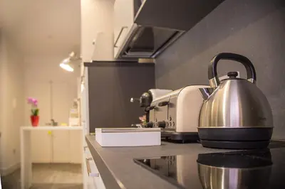 a tea kettle is sitting on a counter in a kitchen at Antinori Vatican Suite in Rome