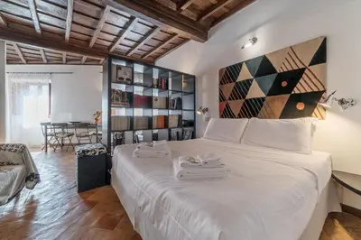 a bedroom with a large white bed in a room at Black White - FromHometoRome in Rome