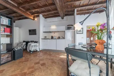 a kitchen and living room with a glass table and chairs at Black White - FromHometoRome in Rome