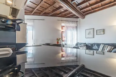 a kitchen with a counter top in a room at Black White - FromHometoRome in Rome