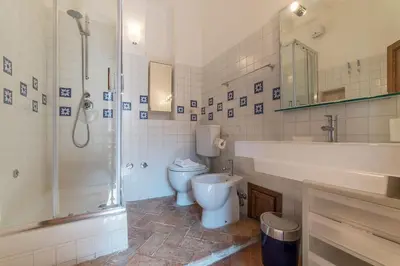 a bathroom with a toilet and a sink and a shower at Black White - FromHometoRome in Rome