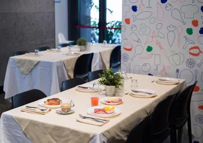 a row of tables with plates of food on them at Camplus Pietralata - Casa per Ferie in Rome