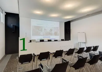 a meeting room with a large screen and chairs at Camplus Pietralata - Casa per Ferie in Rome