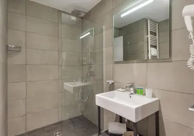 a bathroom with a sink and a shower with a mirror at Camplus Pietralata - Casa per Ferie in Rome