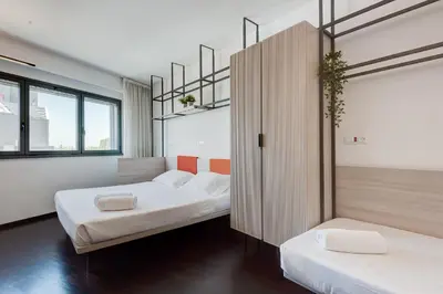 a room with two beds and a partition with two beds at Camplus Pietralata - Casa per Ferie in Rome