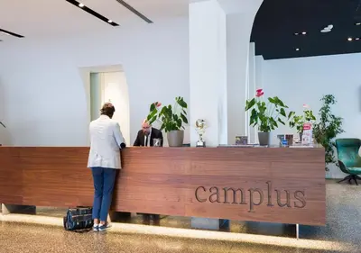 a woman standing at a counter in an airport at Camplus Pietralata - Casa per Ferie in Rome