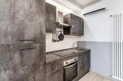 a kitchen with wooden cabinets and a sink at Costaguti 36 Apartment in Rome