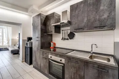 a kitchen with wooden cabinets and a sink at Costaguti 36 Apartment in Rome