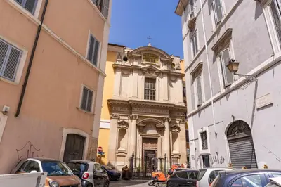 a building on a street with cars parked in front at Costaguti 36 Apartment in Rome