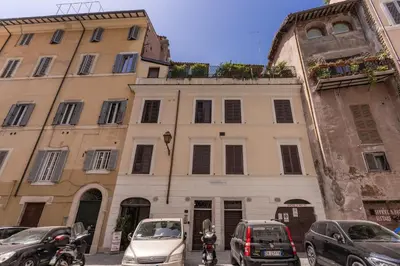 a building with cars parked in front of it at Costaguti 36 Apartment in Rome