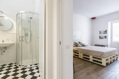 a bathroom with a shower and a bed in a room at Casa Vacanza 