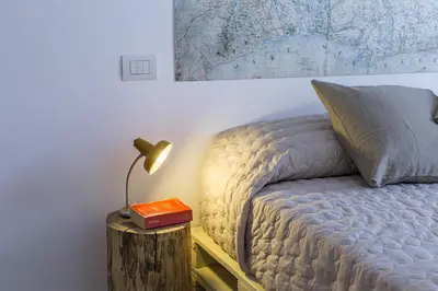 a bedroom with a bed and a lamp on a table at Casa Vacanza 