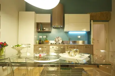 a large kitchen with a glass table in it at Fico Blu in Rome
