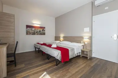 a bedroom with a large bed with a red blanket at La Palma in Rome