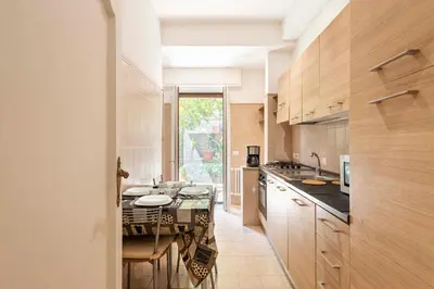 a kitchen with a table and a dining room at Vatican Holiday Apartment 307 in Rome