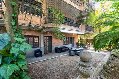 a patio with a table and chairs in front of a building at Vatican Holiday Apartment 307 in Rome