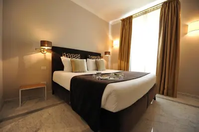a hotel room with a large bed with a window at Angel Spagna Suite in Rome