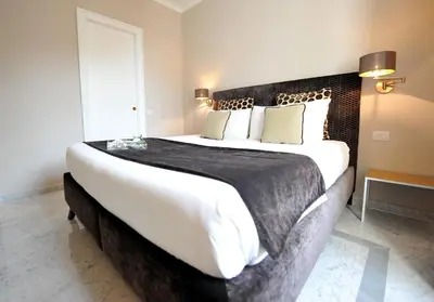 a bedroom with a large bed with a black headboard at Angel Spagna Suite in Rome
