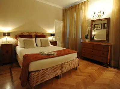 a bedroom with a bed and a mirror and a dresser at Angel Spagna Suite in Rome