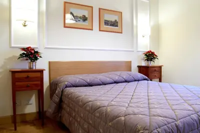 a bedroom with a purple bed and two night stands at Domus Cavour Guest house in Rome