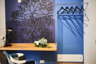 a desk in a room with a blue wall at Domus Cavour Guest house in Rome
