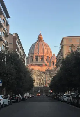 a building with a dome in the middle of a street at Hotel Paolo II in Rome