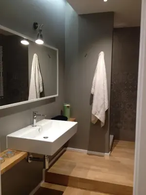 a bathroom with a white sink and a mirror at White Apartment in San Giovanni in Rome