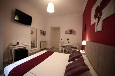 a hotel room with a large bed and a table at Dhome B&B in Rome